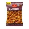 A package of Haldiram's Navrattan Namkeen, featuring a dark maroon bag with a clear window displaying the golden-brown fried snack mix inside. The packaging includes a yellow 'NEW PACK' banner at the top left and a red Haldiram's logo at the top center.