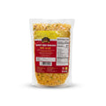 A clear plastic bag of Vajra brand Spicy Mix Snacks (Mix Jhalmuri) containing yellow-orange fried snack pieces, with a red and yellow label, on a white background.