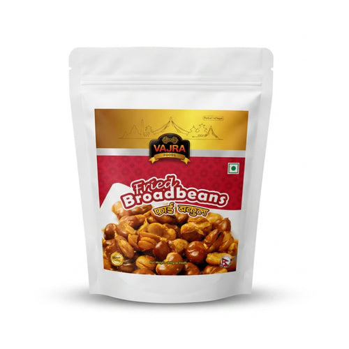 A stand-up pouch of Vajra Brand Fried Broadbeans (Bhuteko Bakulla) on a clean white background. The packaging is white with a prominent red and gold label, featuring a photo of the fried broadbeans on the front.